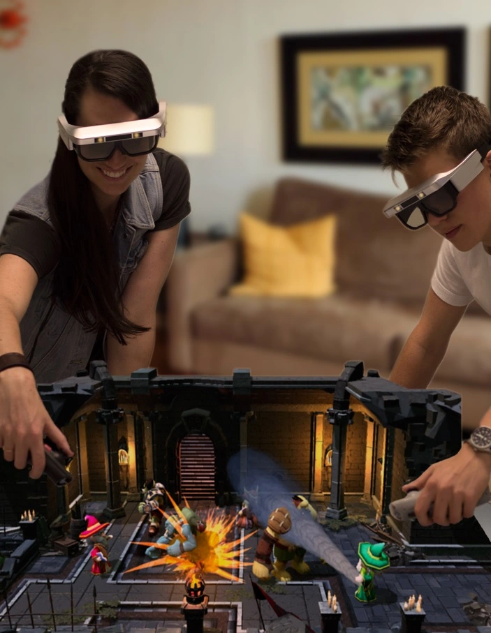 Two people wearing CastAR headsets, playing a dungeon game