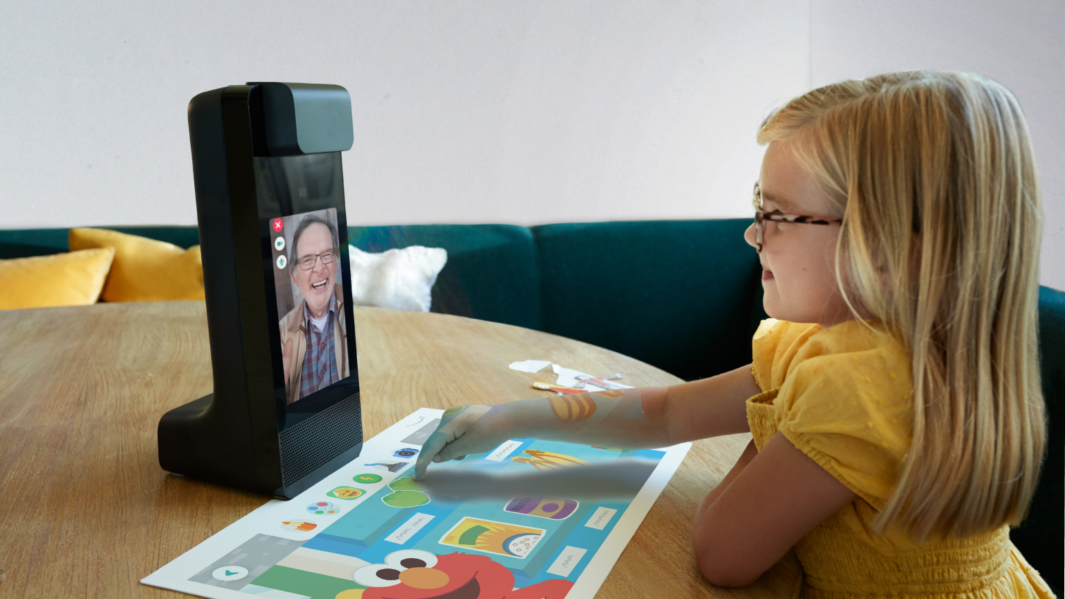 A procam display on a table. A child touching the illuminated tabletop