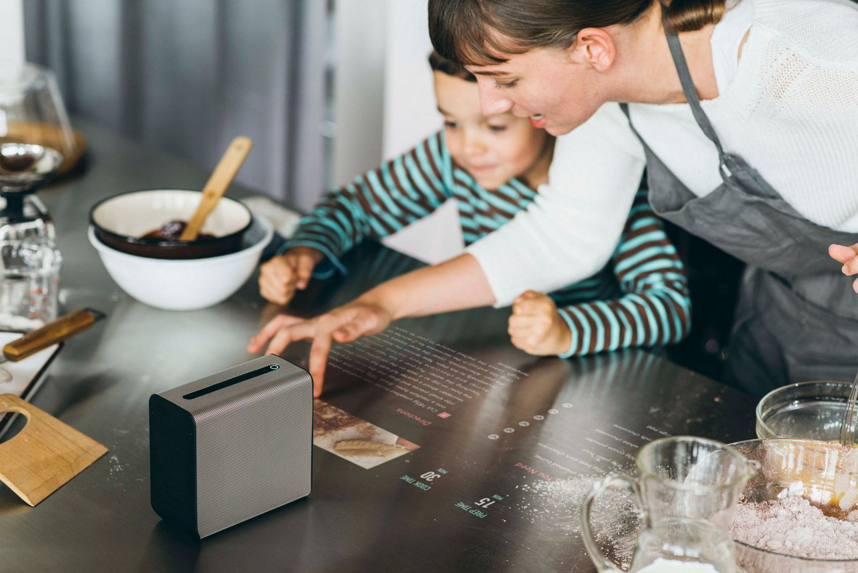 Sony Xperia Touch showing a receipt on a kitchen table. As the cook's hand scrolls the text, it casts a shadow, but the shadow seems to have been Photoshopped