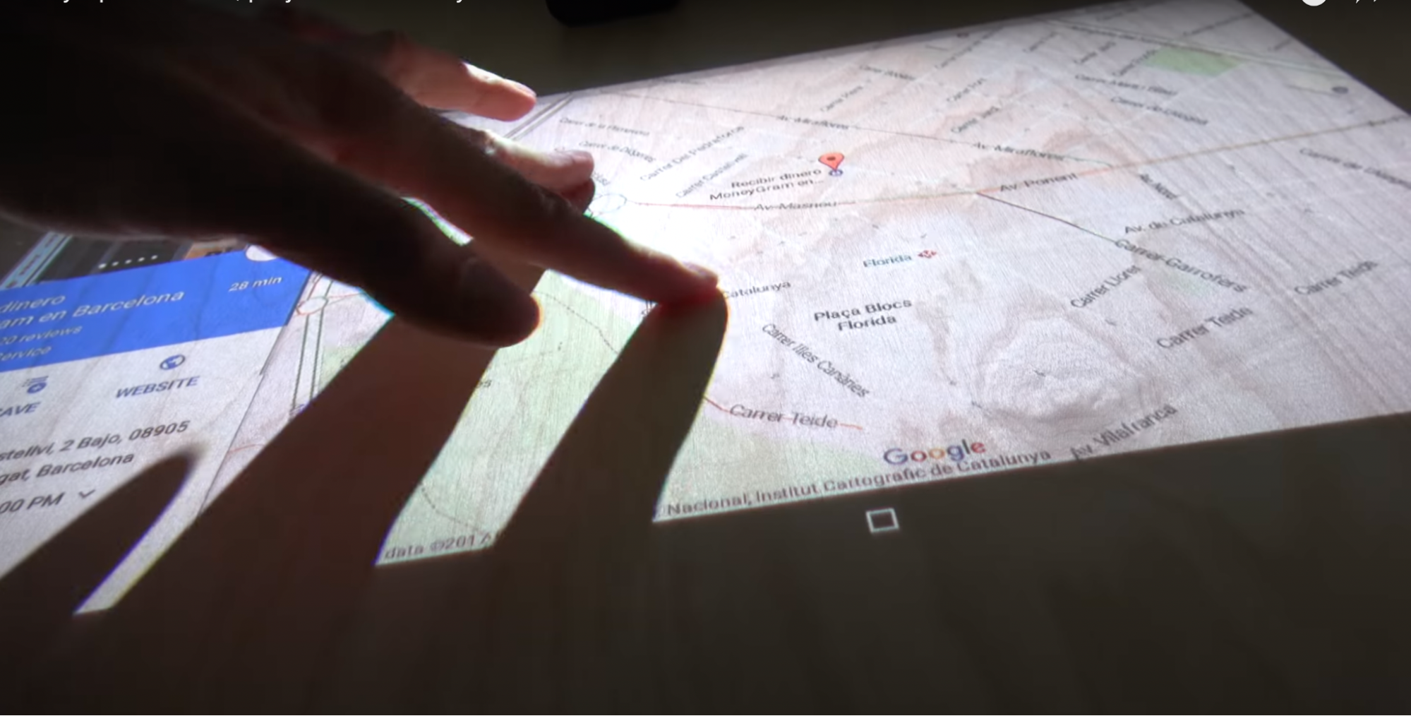 Sony Xperia Touch shows a map. The user is dragging the map, but in the
process, casting a shadow on the image, occluding some of the map